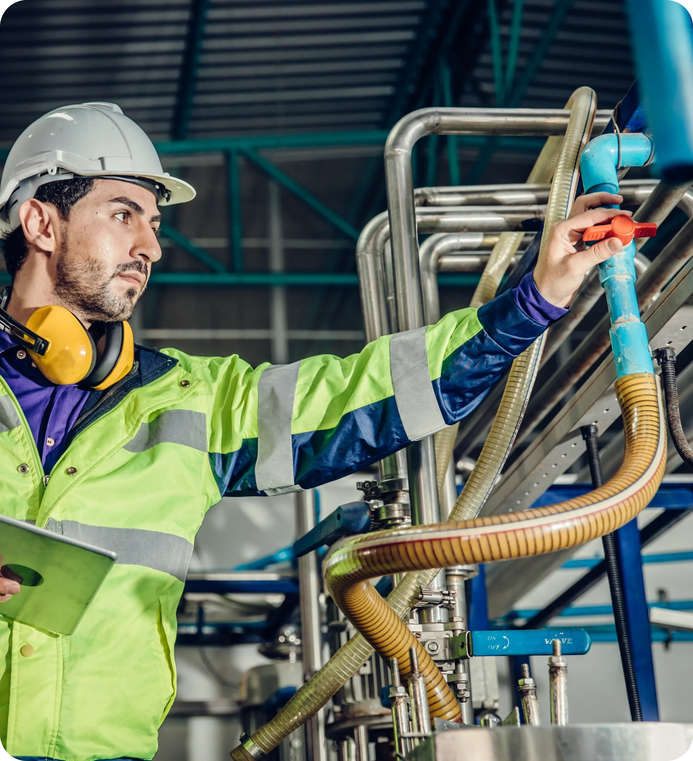 A man in yellow jacket holding hose and clipboard.